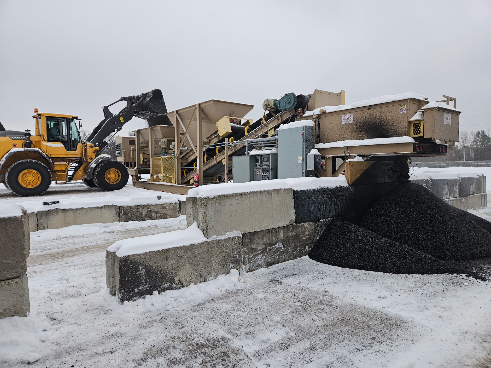 Blackstone Technologies cold patch mix production facility in winter with loader and asphalt mixing equipment