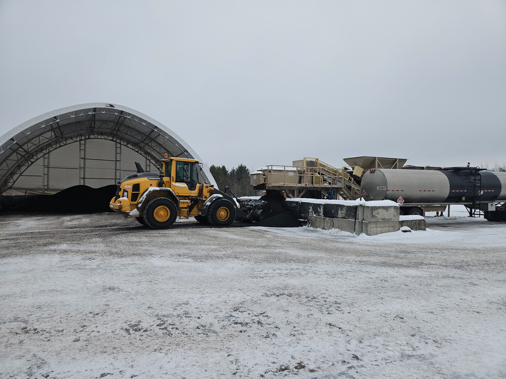 Blackstone Technologies production facility with Volvo loader, storage dome, and mixing equipment in winter